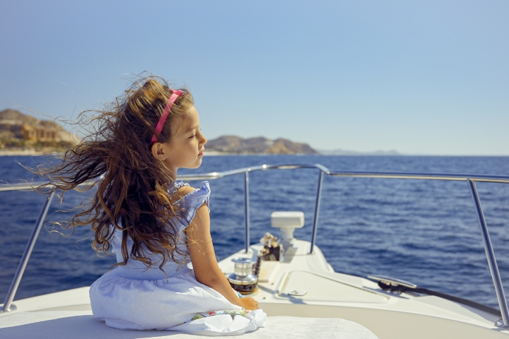 Young girl looking at horizem on FreeStyle's bow seatting area