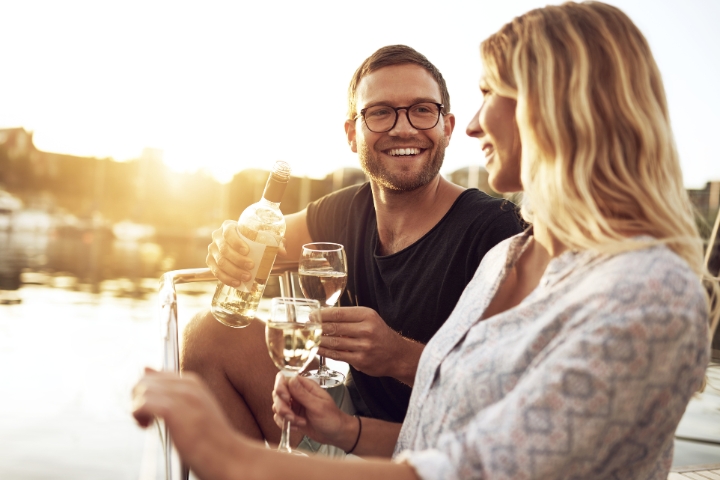 Couple sharing wine on sunset cruise