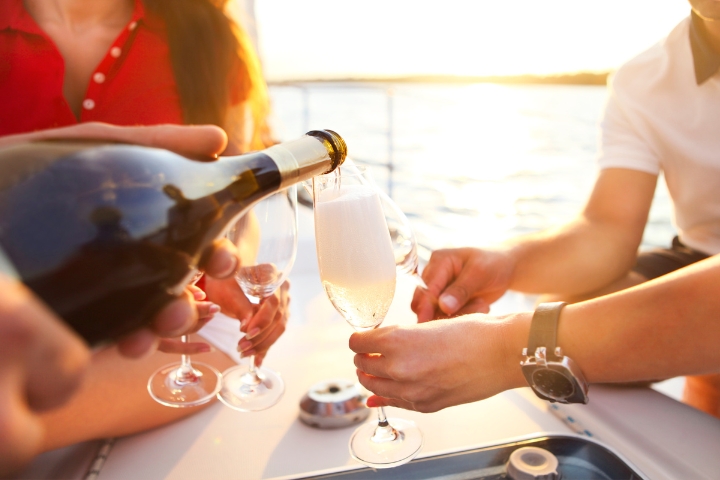 Pouring champagne into glasses on the boat