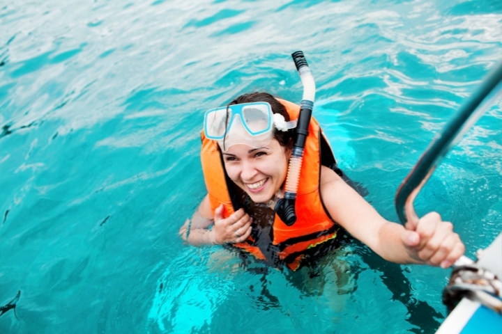 Snorkeler returning to the boat after a swim